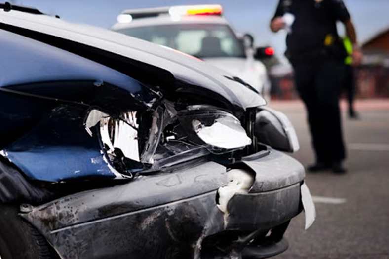 policia revisando un auto en la escena de un accidente