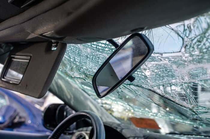 A cracked windshield after being in a car accident.