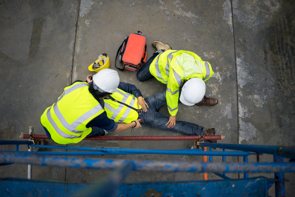 construction workers helping contruction accident victim