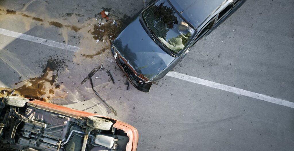 An aerial view of two severely damaged vehicles after a car accident.