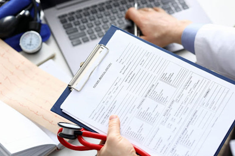 doctor holding medical record document of a patient