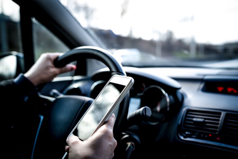 driving distracted with a smartphone in one hand