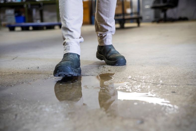 guy about to slip on a puddle of water at work