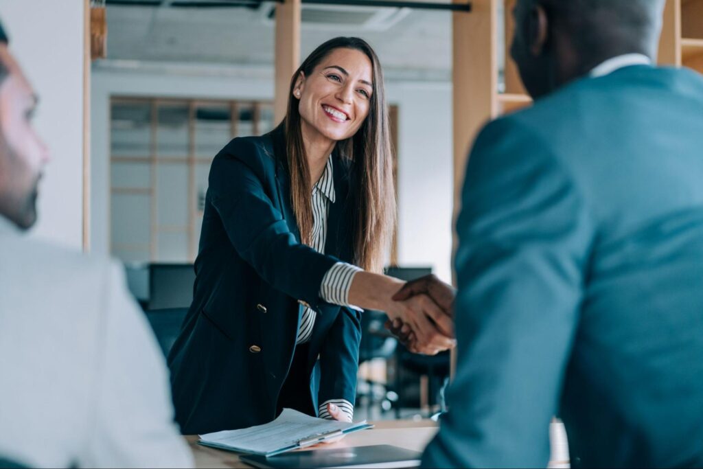 employment law attorney shaking a client's hand while smiling
