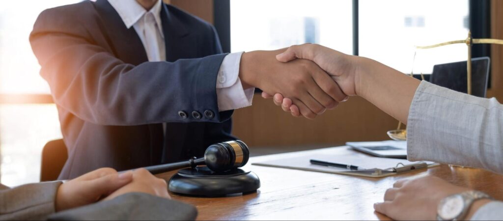 personal injury lawyer shaking client's hand