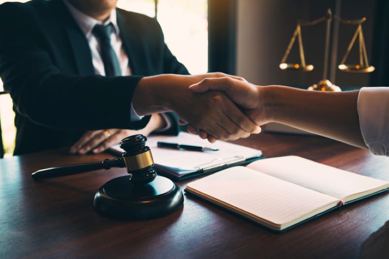 Lawyer is currently shaking hands with the client
