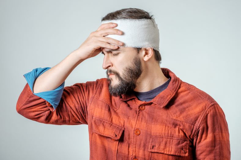 man holding head in pain