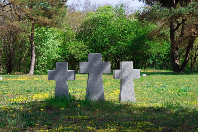 three cemetery crosses in a field