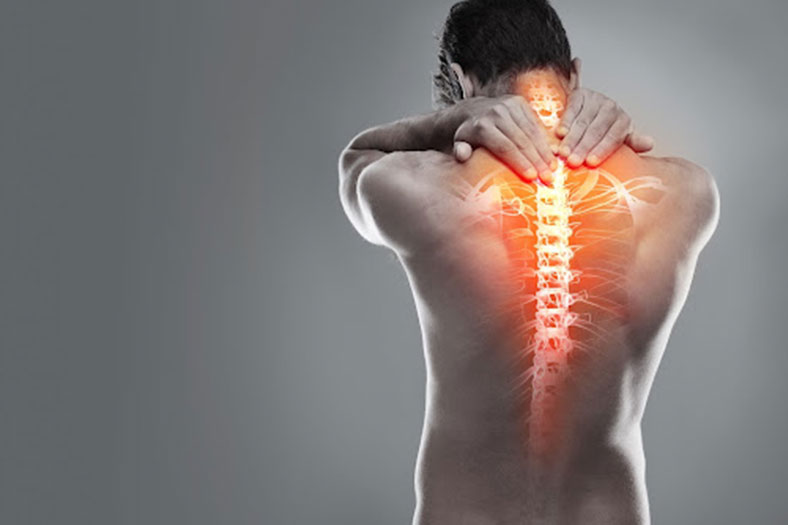 spinal pain of man with hands on the back of his neck