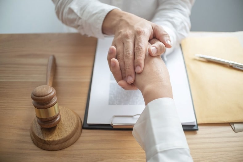 car accident lawyer shaking hands with a client