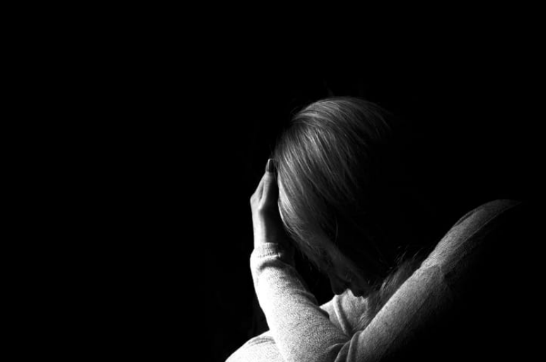 a black and white photo of a sexual assault victim in distress