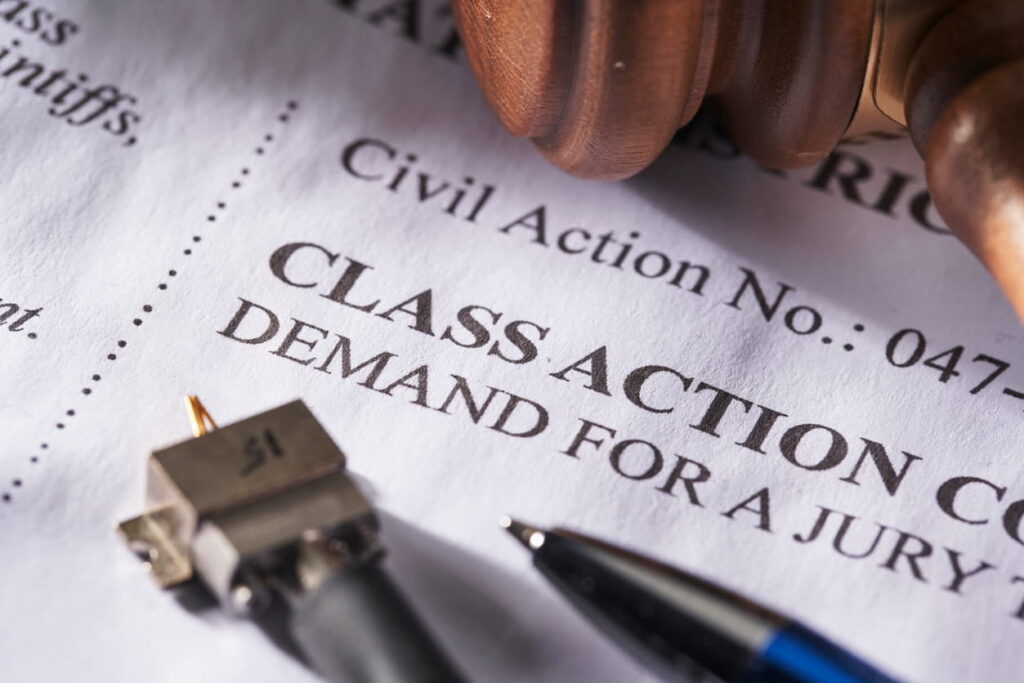 An up-close view of a form that reads: "class action - deman for jury" in regards to a class action lawsuit.
