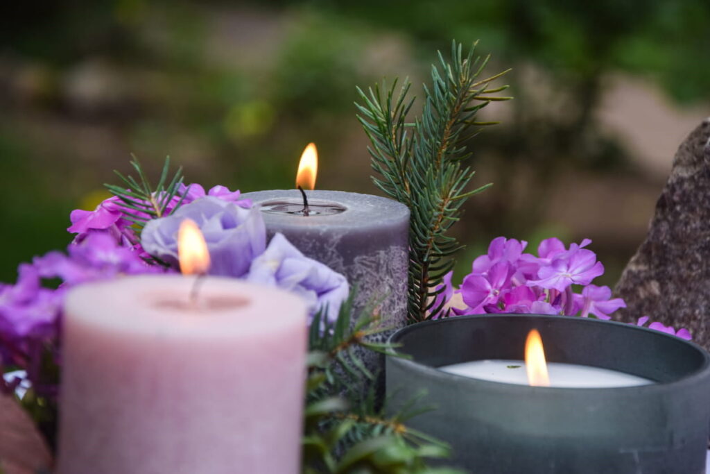Purple flowers and candles in memorial of a wrongful death victim.