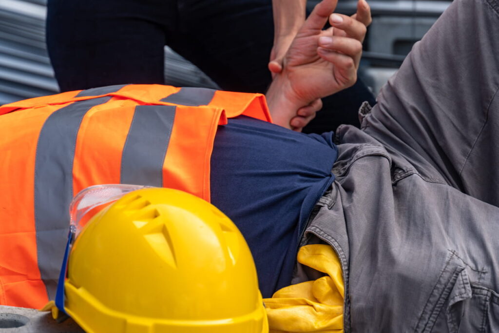 A medic checking on a construction worker after a catastrophic injury.