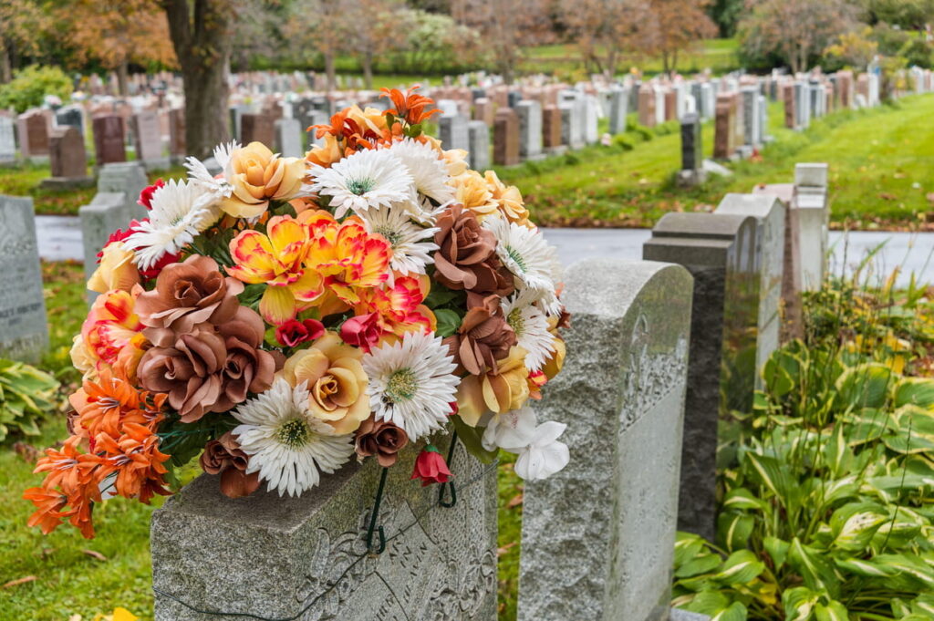 An array of flowers left on a grave after a wrongful death.