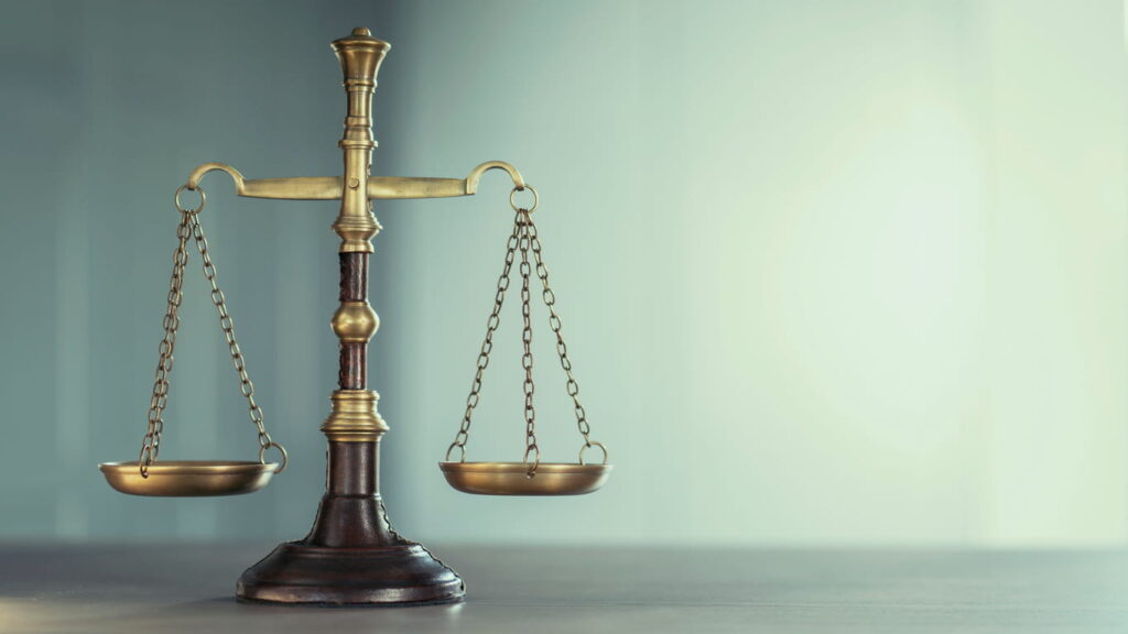 The scales of justice on an auto accident lawyer's desk.