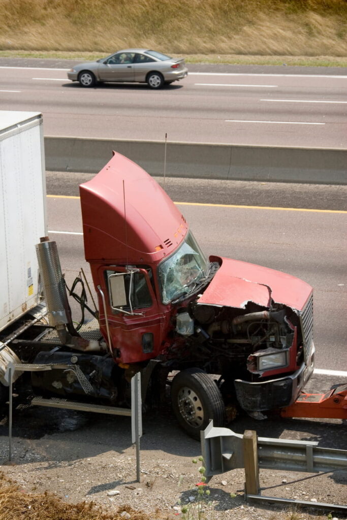 A damaged front end of a semi-truck after being in an accident.