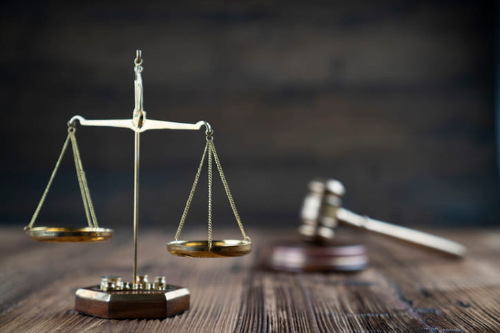 The scales of justice and a gavel on a car accident attorney's desk. 