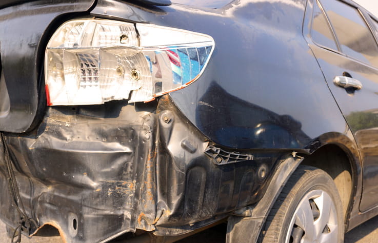 A damaged back end of a vehicle after a car accident. 