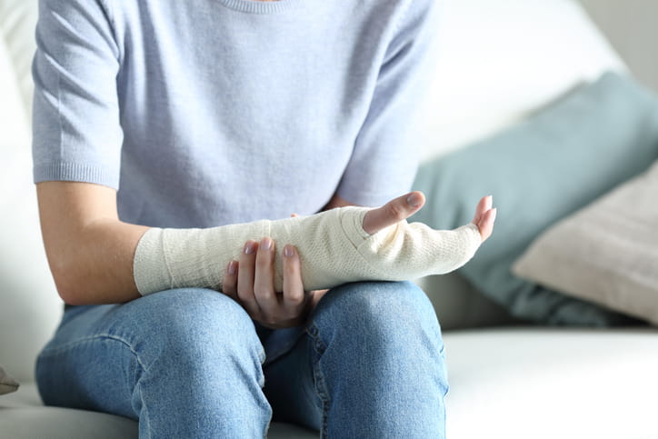 A person with a broken arm in a cast.