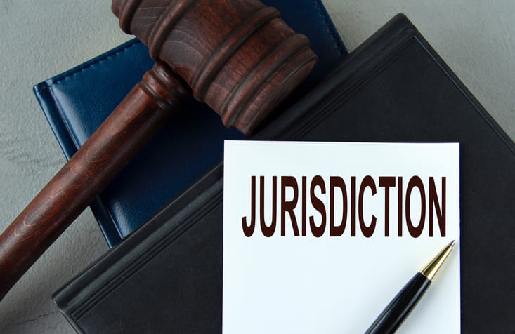 A gavel next to a paper that reads "Jurisdiction."