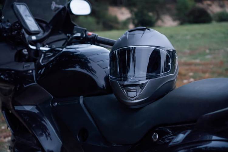 A helmet sitting on a motorcycle.