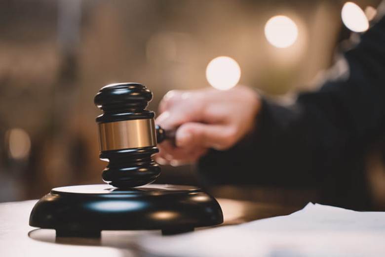 A judge using a wooden gavel.